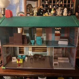1950s Era vintage metal dollhouse with plastic furniture included.
